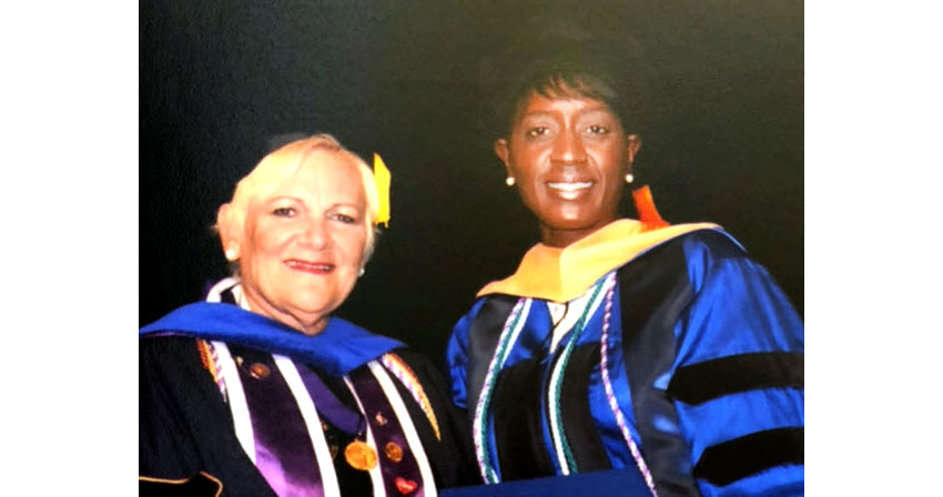 DNP Graduate Bridges Project on Traumatic Brain Injury to Practice Dr. Melani Bell with Dr. Susan Goenwald at graduation