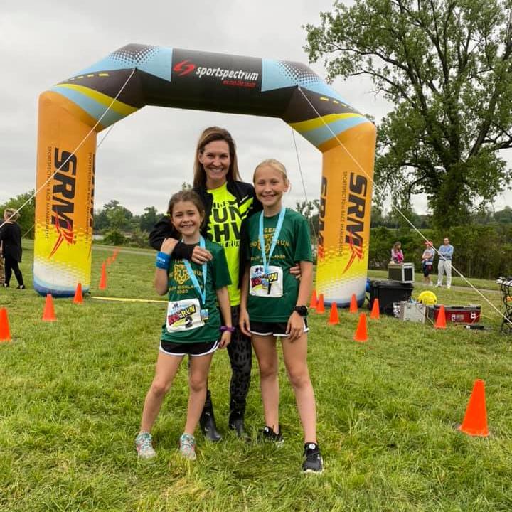 Woman with two girls at racing location.