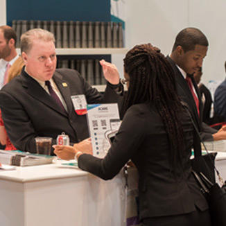woman visiting ACAMS exhibit booth