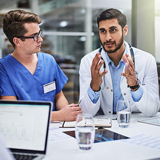 doctor and nurse discussing at a table