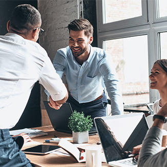 man shaking someone's hand in an office