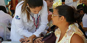 doctor tending to a patient in a crowd