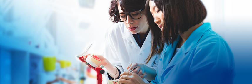 Two medical students running a test in a lab