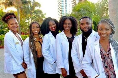 Medical students standing together in their white coats