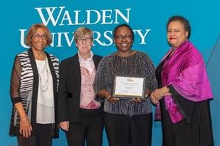 Dr. Cora Jackson accepting an award from Walden University