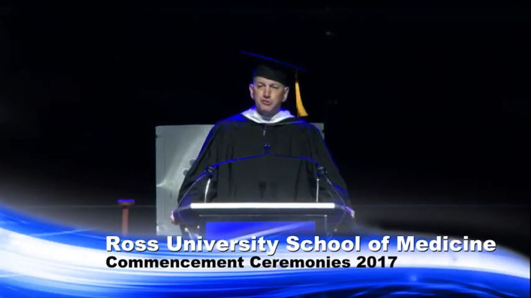 graduation speaker on stage addressing audience