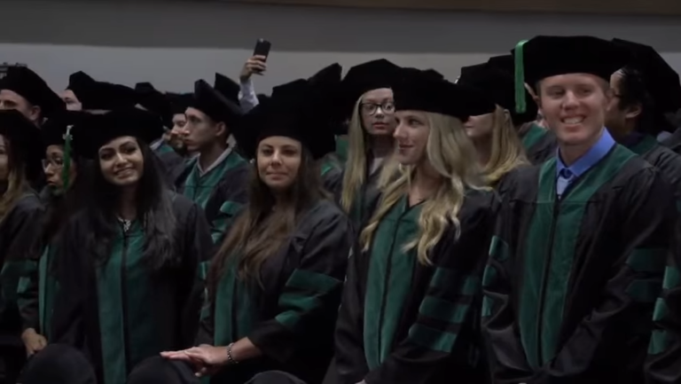 students standing at graduation