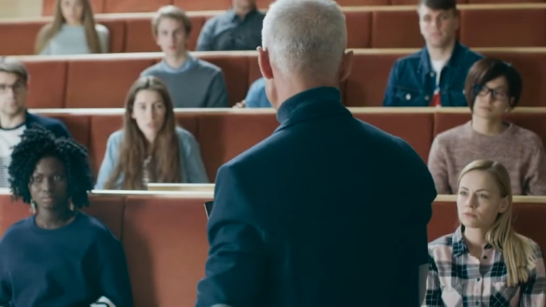 man speaks to class of students 