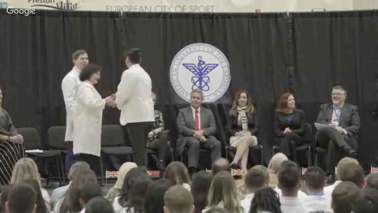 student receiving honor on graduation stage