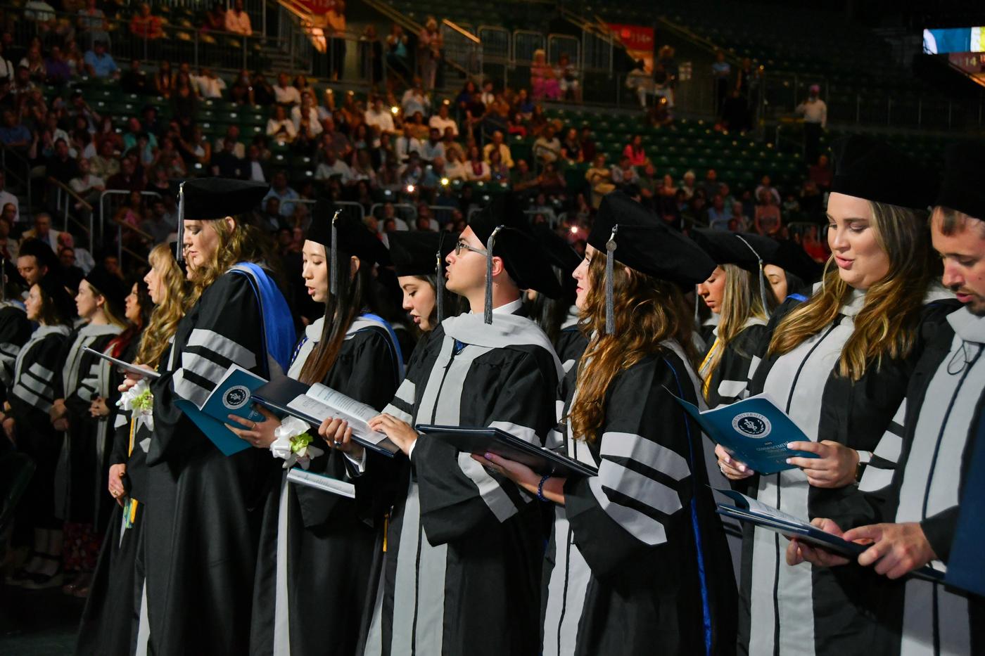Group of students in robes are commencement