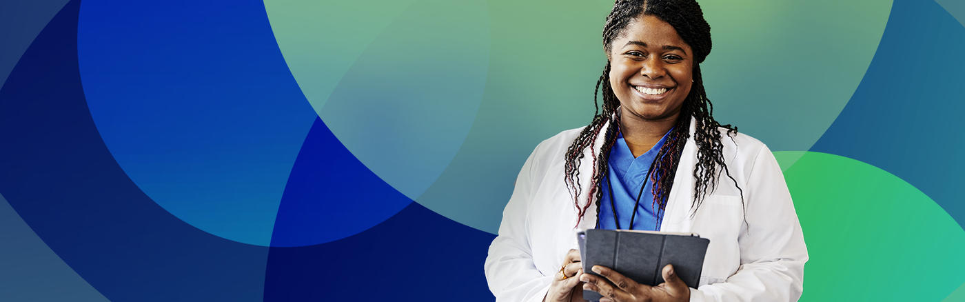 Smiling woman in lab coat holding documents