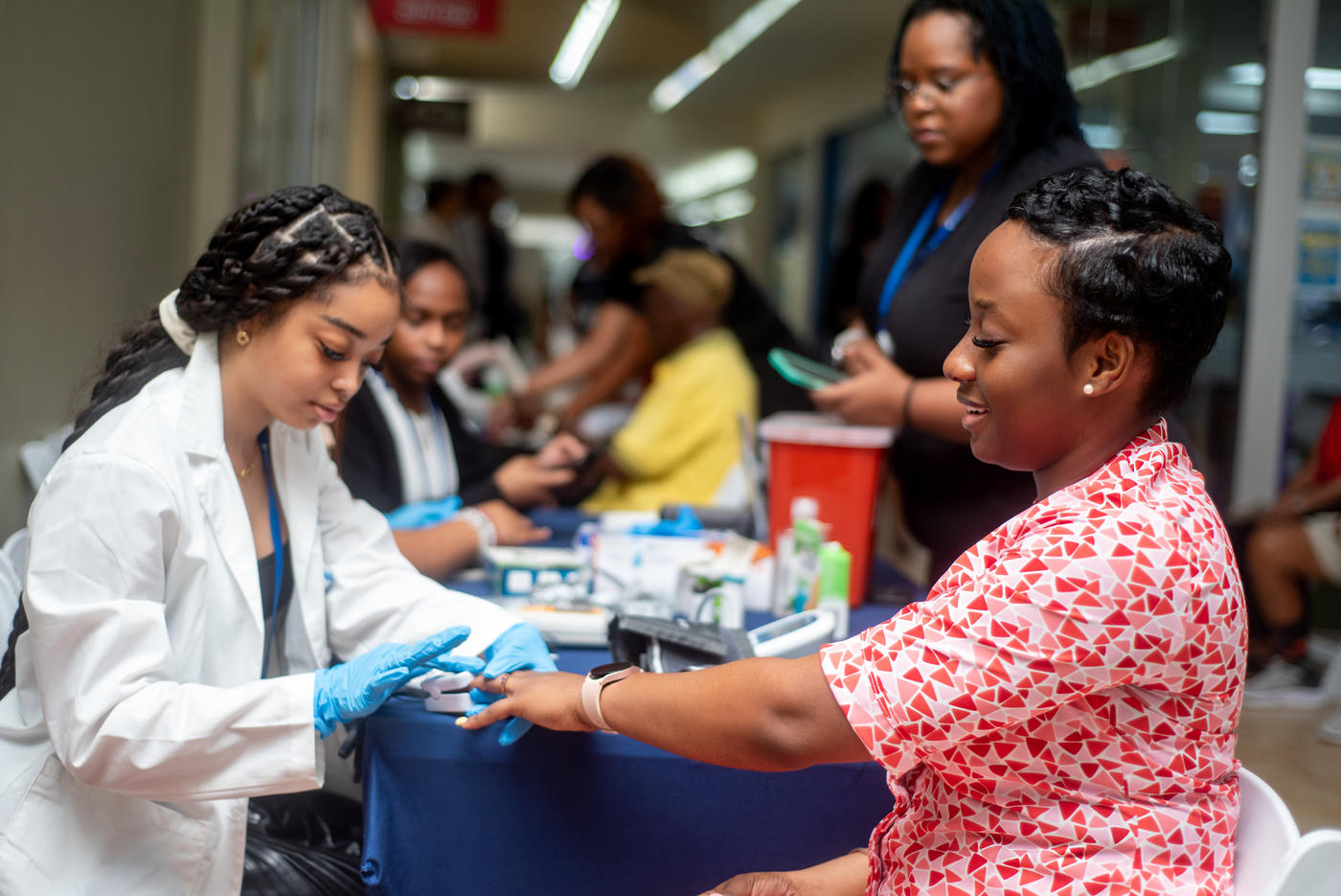 a Spelman University students performs a supervised health screening