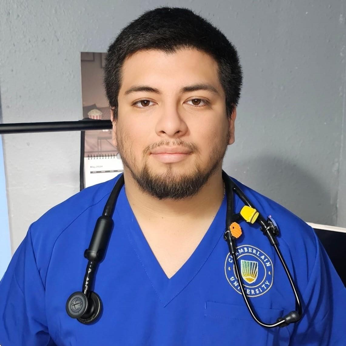 Jairo Monjaraz, Chamberlain student, wearing nursing scrubs