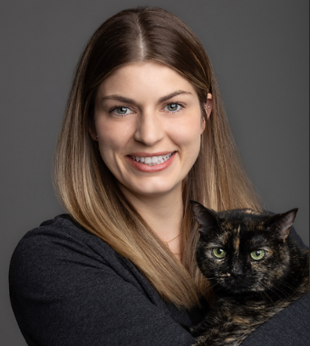 a headshot of Dr. Kelsey Bertamus holding a cat