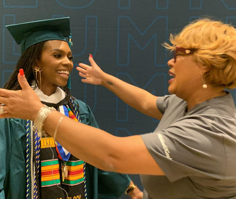 Woman hugging graduate
