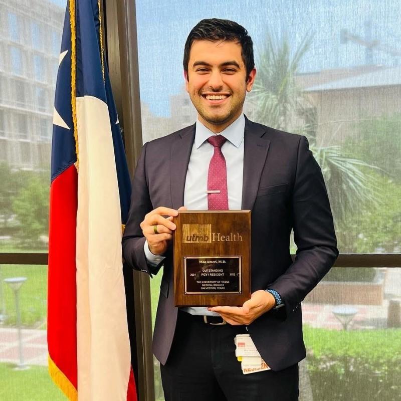 a photo of Dr. Moe Ameri accepting an award