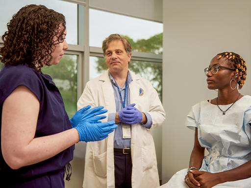 Two medical professionals speaking with a patient