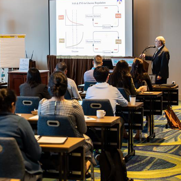 Lecture classroom with man presenting at podium