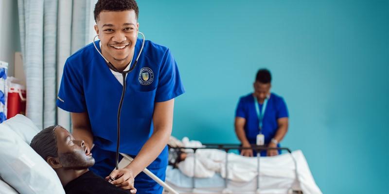 A person in blue scrubs with a stethoscope