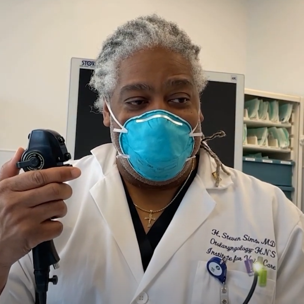 Medical professional in white lab coat demonstrating a medical procedure