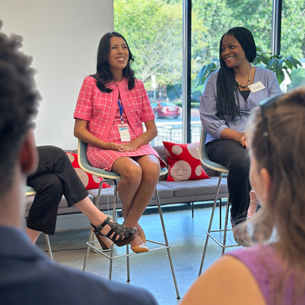 Two women speaking to a group.