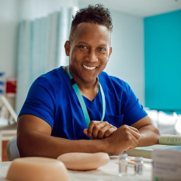 Male nurse sitting at working desk