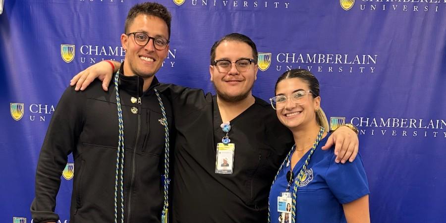 Jesus Garcia with two Chamberlain students