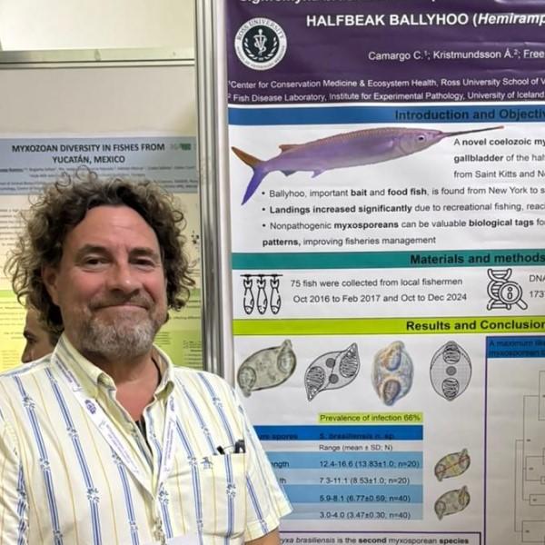 A man standing in front of a diagram of a fish