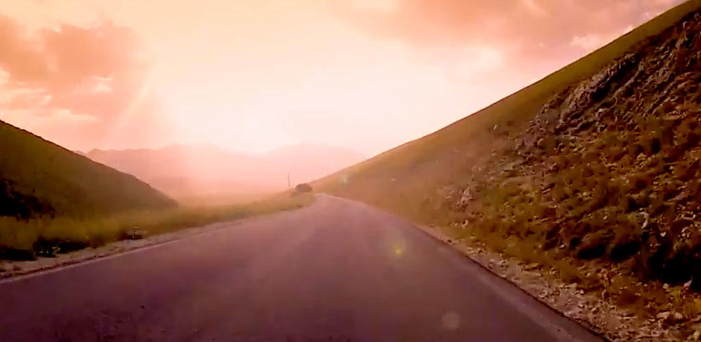 scenic photo looking down a road through mountains