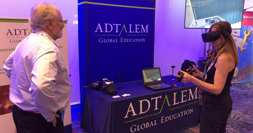 woman trying virtual viewer at an Adtalem exhibit booth