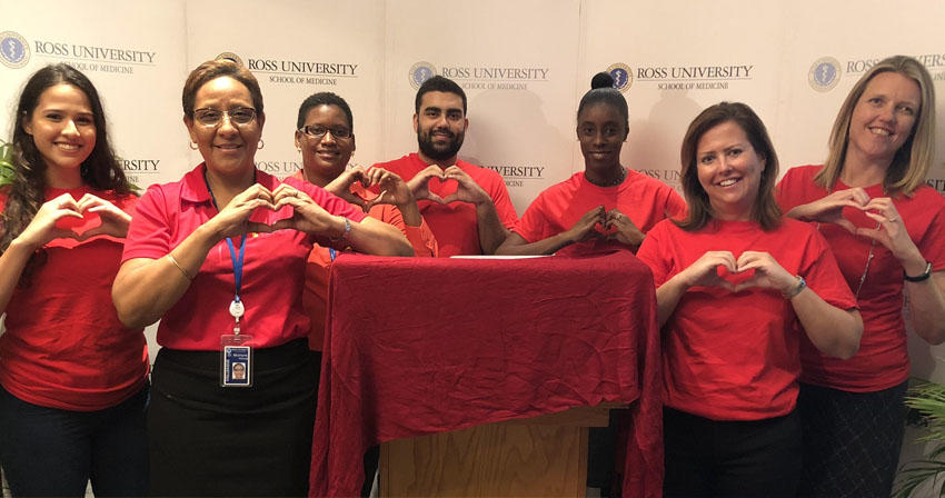 group posing with heart-shaped hands