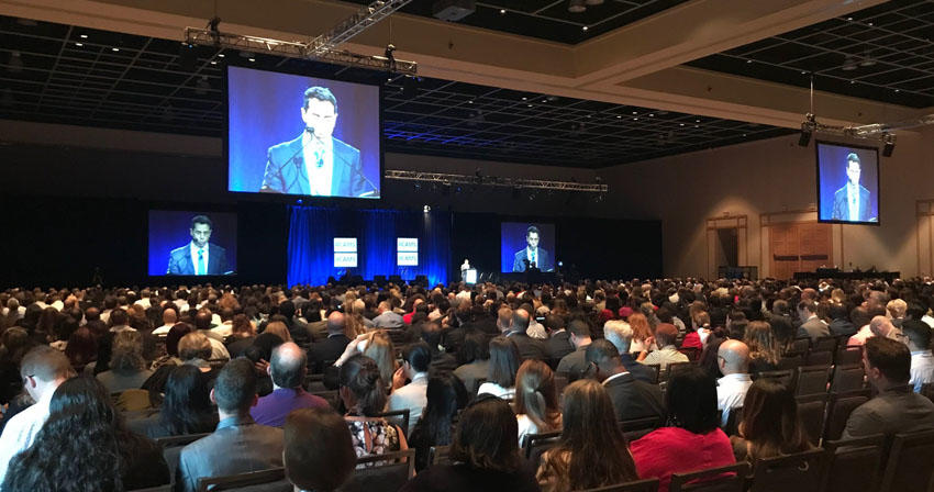 Conference attendees listening to a speaker