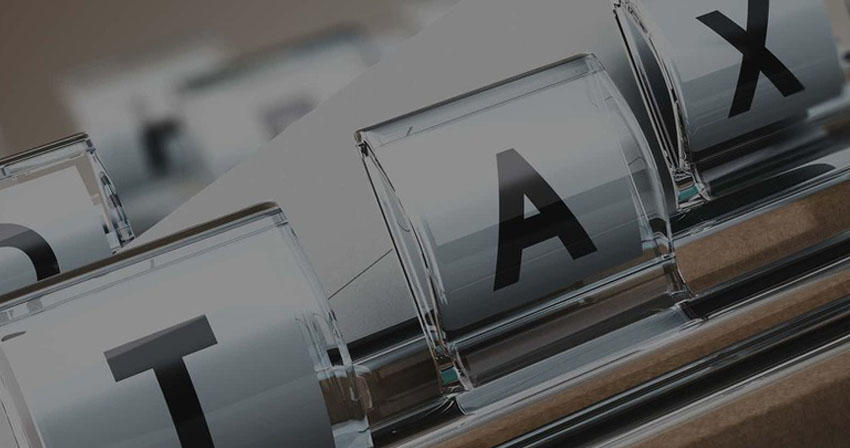 macro photo of letters T-A-X