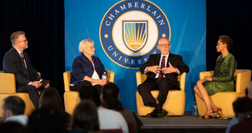 Chamberlain leaders speaking at a panel on stage