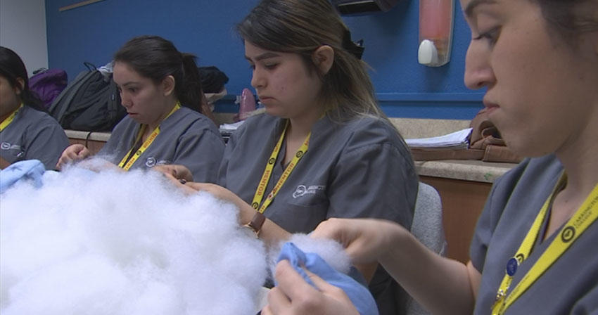 volunteer students stuffing pillows