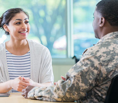 Woman talking with a man in army fatigues