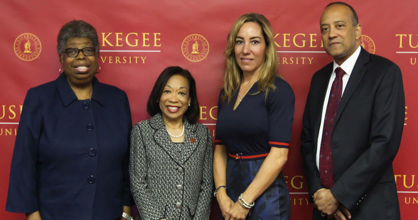 Adtalem and Tuskegee leaders in front of a backdrop
