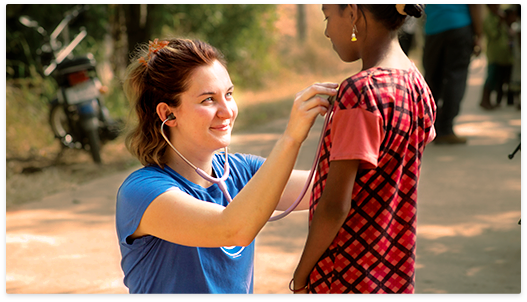 global nurse examining a child with a stethoscope