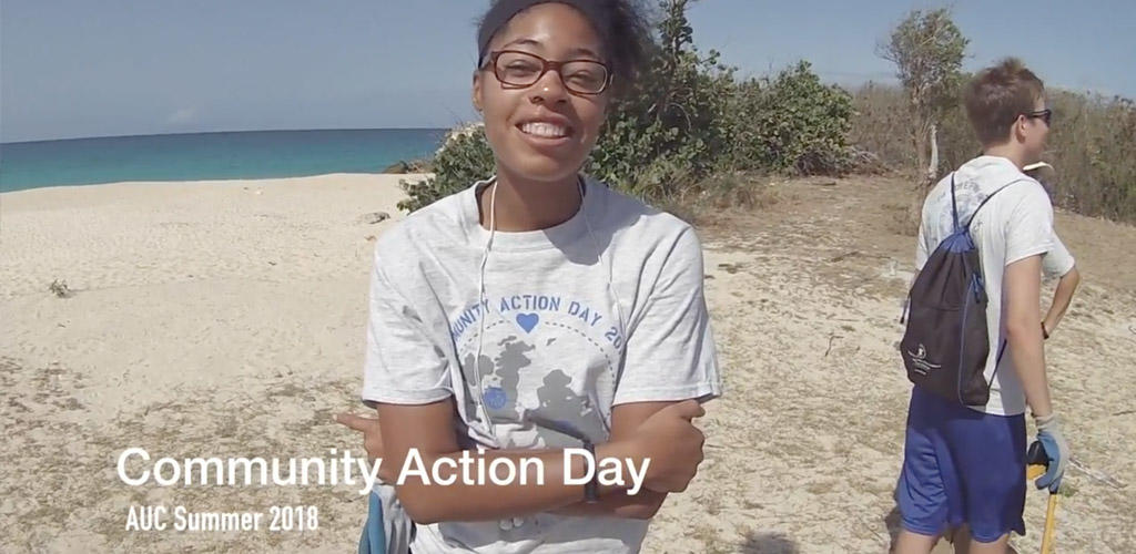 video still frame of students volunteering on a beach