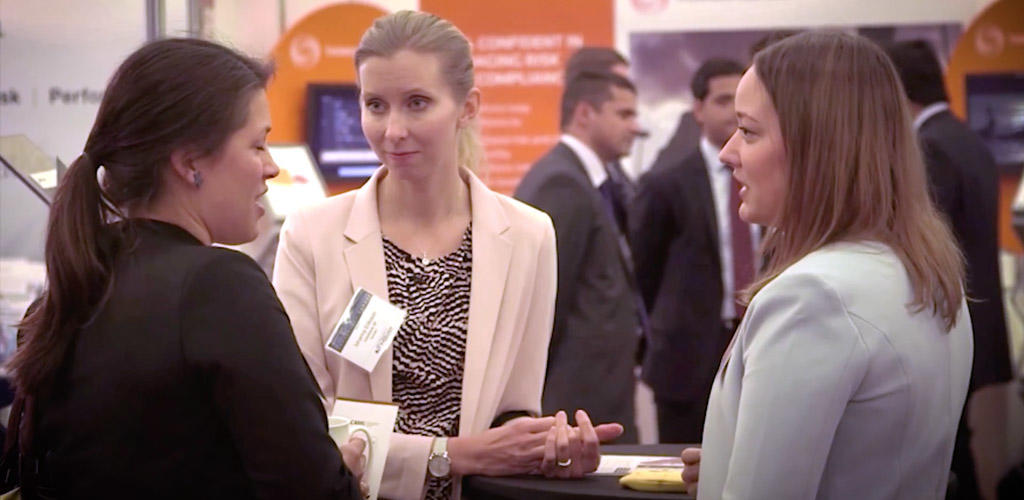 group speaking at an exhibit booth